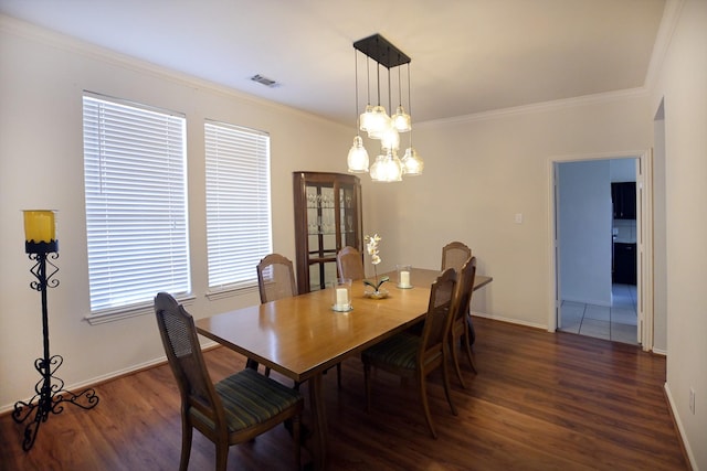 5315 Summit Knoll Trl, Sachse, TX 75048 - dining space with dark wood-style flooring, ornamental molding, baseboards, and a chandelier