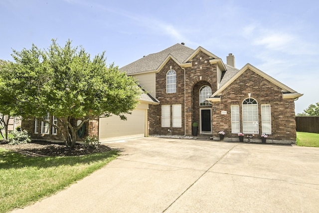 5315 Summit Knoll Trl, Sachse, TX 75048 - traditional-style house with driveway, a chimney, brick siding, a garage, and roof with shingles