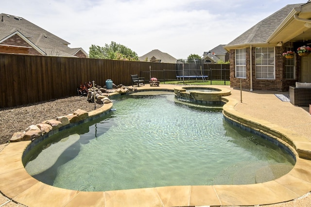 5315 Summit Knoll Trl, Sachse, TX 75048 - view of swimming pool featuring a fenced backyard, a patio area, a pool with connected hot tub, and a trampoline