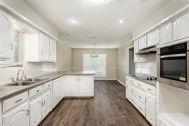 7102 Timberline Dr, Rowlett, TX 75089 - kitchen with stainless steel oven, a sink, a peninsula, under cabinet range hood, and dishwasher