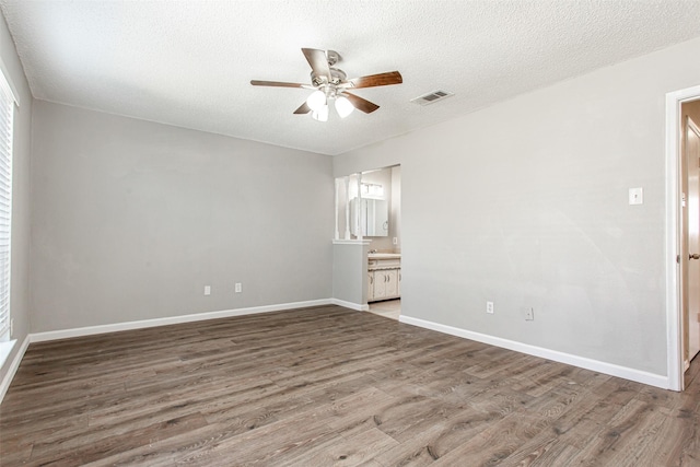 7102 Timberline Dr, Rowlett, TX 75089 - spare room with ceiling fan, wood finished floors, a textured ceiling, and baseboards