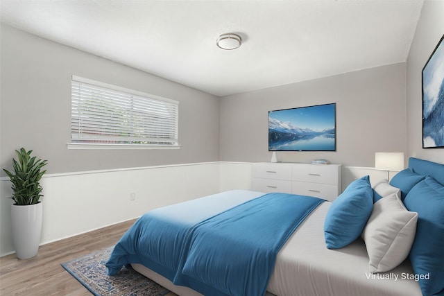 7102 Timberline Dr, Rowlett, TX 75089 - bedroom with wood finished floors and a wainscoted wall