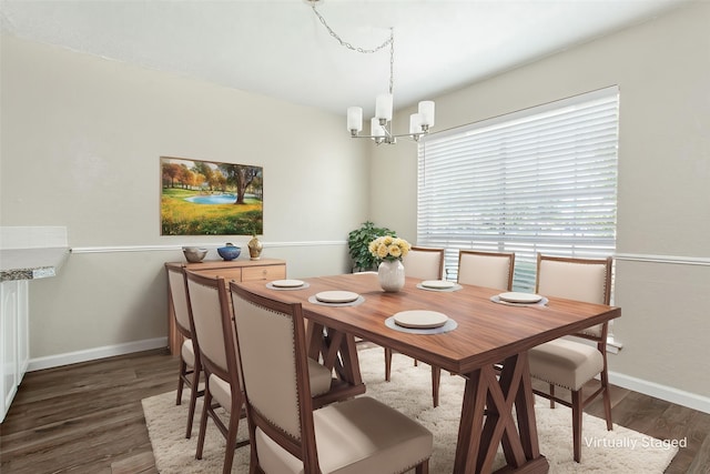 7102 Timberline Dr, Rowlett, TX 75089 - dining room featuring a chandelier, wood finished floors, and baseboards