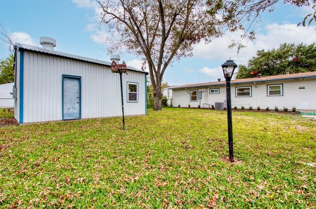 11521 Fernald Ave, Dallas, TX 75218 - view of green lawn with cooling unit and an outbuilding