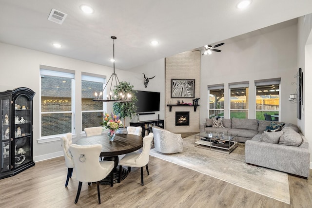 507 N Eagle Point Rd, Van Alstyne, TX 75495 - dining area featuring ceiling fan, wood finished floors, a fireplace, a chandelier, and recessed lighting