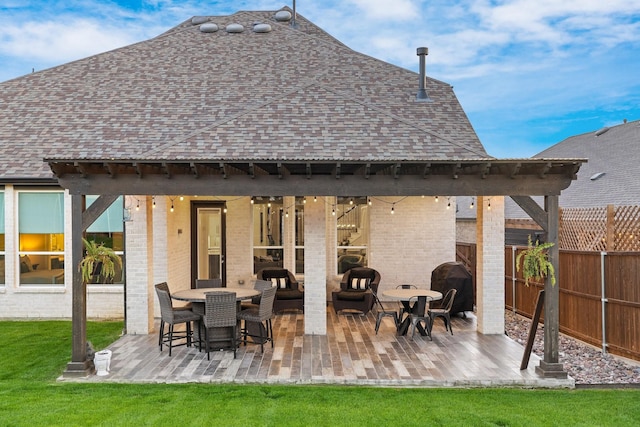 507 N Eagle Point Rd, Van Alstyne, TX 75495 - rear view of house with a shingled roof, brick siding, and a patio area