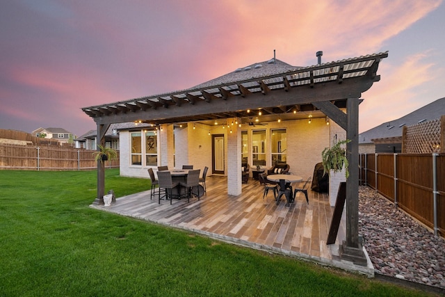 507 N Eagle Point Rd, Van Alstyne, TX 75495 - back of property at dusk featuring outdoor dining space, brick siding, and a pergola