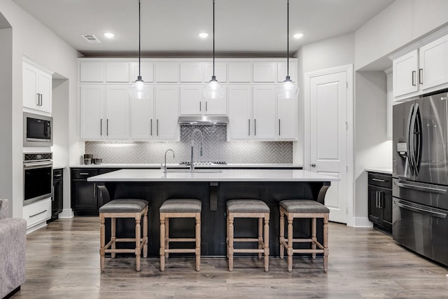 507 N Eagle Point Rd, Van Alstyne, TX 75495 - kitchen featuring stainless steel appliances, light countertops, backsplash, a kitchen bar, and recessed lighting
