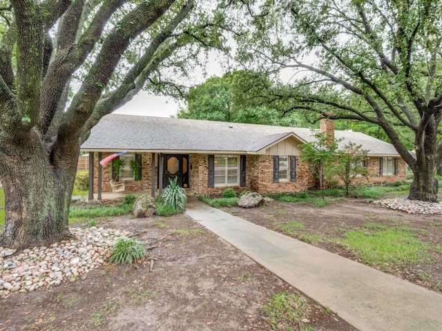 12151 Crestline Ave, Dallas, TX 75244 - ranch-style home featuring covered porch, a chimney, and brick siding