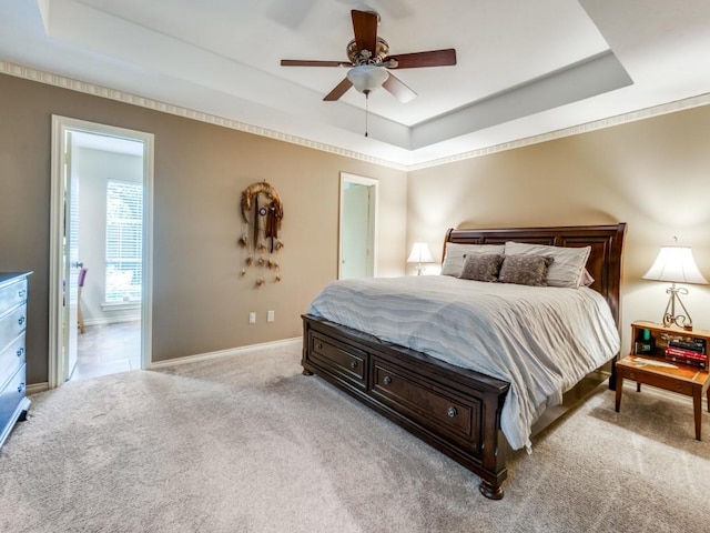 12151 Crestline Ave, Dallas, TX 75244 - bedroom featuring a raised ceiling, carpet floors, baseboards, ensuite bath, and a ceiling fan
