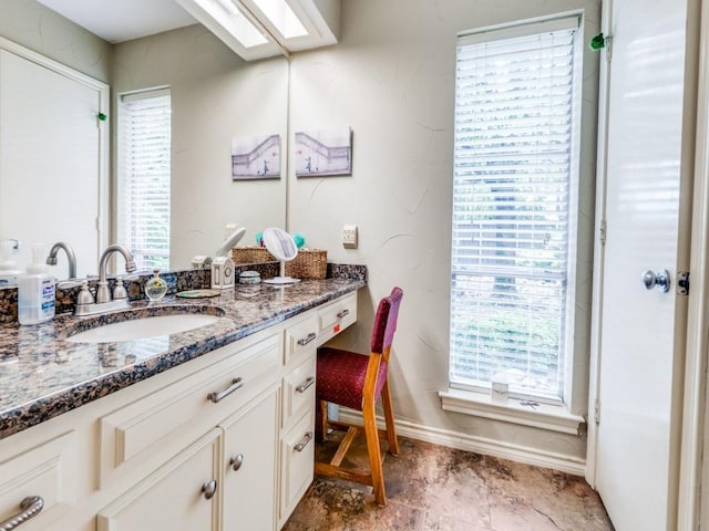 12151 Crestline Ave, Dallas, TX 75244 - bathroom featuring baseboards, vanity, and plenty of natural light