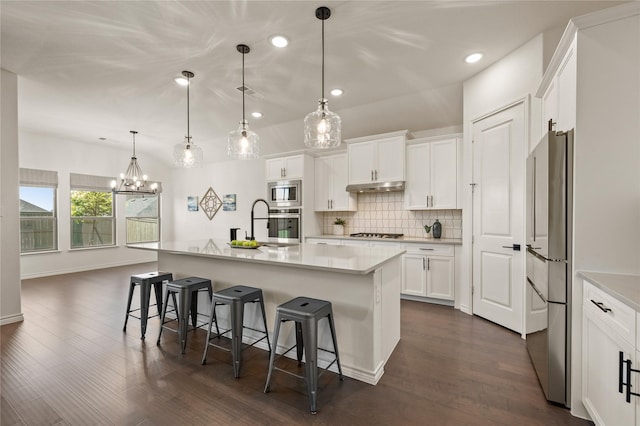 2901 Little Wonder Ln, Northlake, TX 76247 - kitchen featuring stainless steel appliances, under cabinet range hood, decorative backsplash, light countertops, and recessed lighting