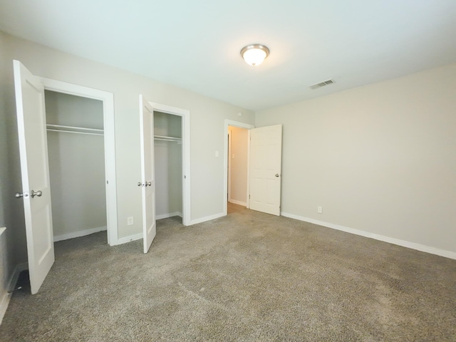 4318 York St, Dallas, TX 75210 - unfurnished bedroom featuring multiple closets, carpet floors, and baseboards