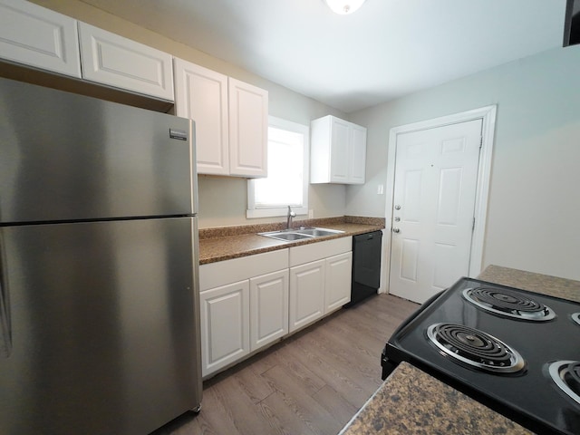 4318 York St, Dallas, TX 75210 - kitchen with black appliances, a sink, white cabinetry, and wood finished floors