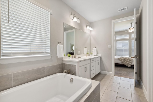 2415 Preakness Pl, Celina, TX 75009 - full bath with double vanity, tiled bath, ensuite bathroom, a ceiling fan, and tile patterned flooring