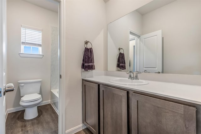 3932 Oak Creek Cir, Denison, TX 75020 - full bath featuring wood finished floors, toilet, vanity, and baseboards