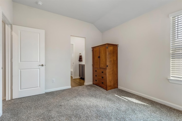 3932 Oak Creek Cir, Denison, TX 75020 - unfurnished bedroom featuring carpet floors, vaulted ceiling, and baseboards
