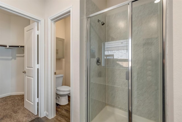 3932 Oak Creek Cir, Denison, TX 75020 - full bathroom with a stall shower, toilet, and a walk in closet