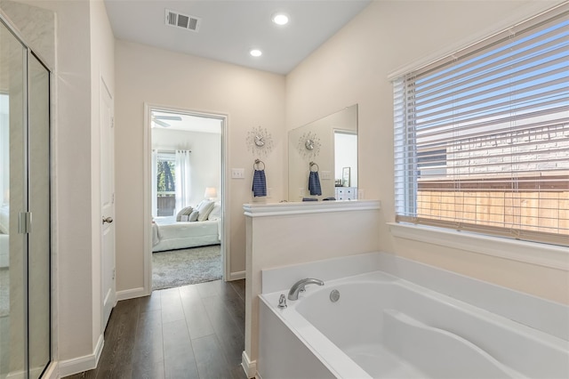 3932 Oak Creek Cir, Denison, TX 75020 - full bath featuring connected bathroom, wood finished floors, a stall shower, a garden tub, and recessed lighting