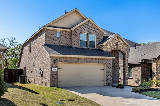 3932 Oak Creek Cir, Denison, TX 75020 - view of front of house with cooling unit, brick siding, concrete driveway, and a garage