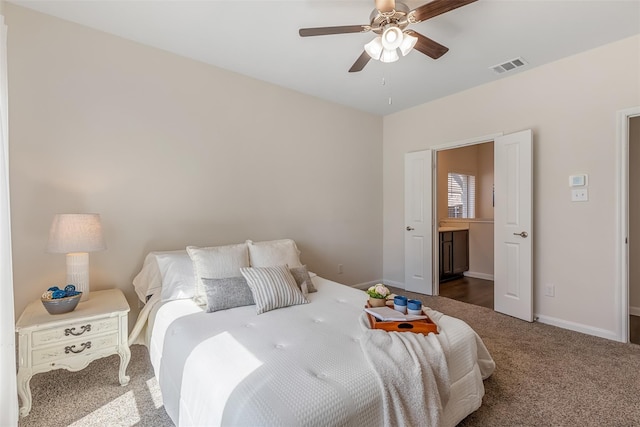 3932 Oak Creek Cir, Denison, TX 75020 - carpeted bedroom featuring baseboards, a ceiling fan, and connected bathroom