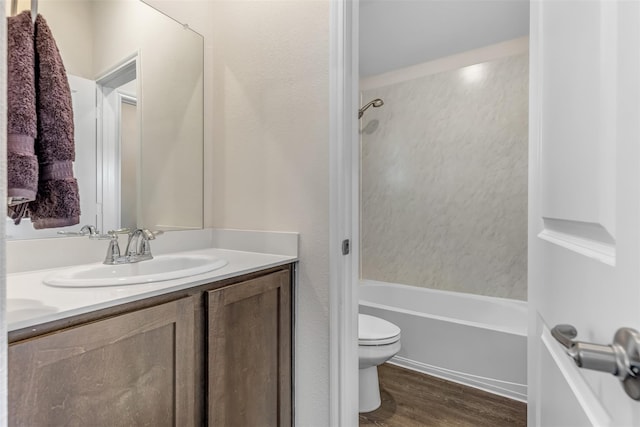 3932 Oak Creek Cir, Denison, TX 75020 - full bathroom with toilet, wood finished floors, vanity, and bathtub / shower combination