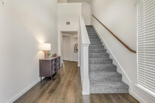 3932 Oak Creek Cir, Denison, TX 75020 - stairway featuring wood finished floors, a towering ceiling, and baseboards