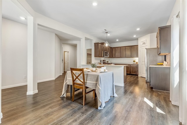 3932 Oak Creek Cir, Denison, TX 75020 - kitchen featuring stainless steel appliances, light countertops, a kitchen island, dark wood-style floors, and recessed lighting