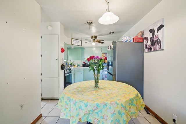 dining space with light tile patterned flooring, ceiling fan, and baseboards