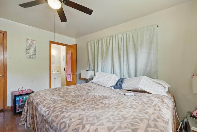 bedroom with dark wood finished floors, connected bathroom, and a ceiling fan