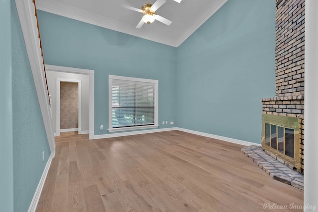 3532 Eastlake Dr, Shreveport, LA 71105 - unfurnished living room featuring ornamental molding, ceiling fan, a brick fireplace, wood finished floors, and baseboards
