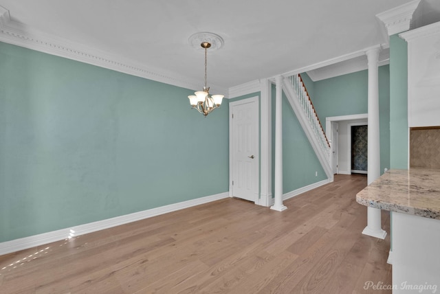 3532 Eastlake Dr, Shreveport, LA 71105 - unfurnished dining area featuring light wood finished floors, baseboards, ornamental molding, a chandelier, and stairs