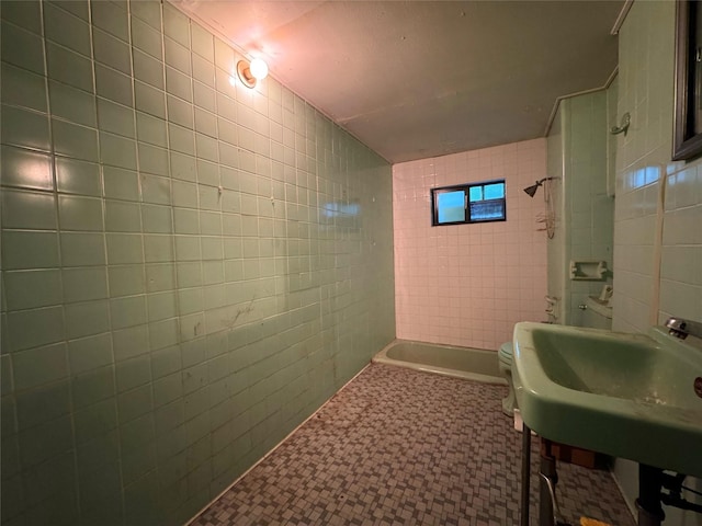 1934 Kessler Pkwy, Dallas, TX 75208 - bathroom with tile walls, toilet,  shower combination, tile patterned floors, and a sink