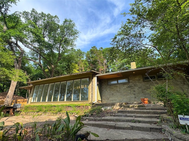 1934 Kessler Pkwy, Dallas, TX 75208 - rear view of house with a chimney and a sunroom