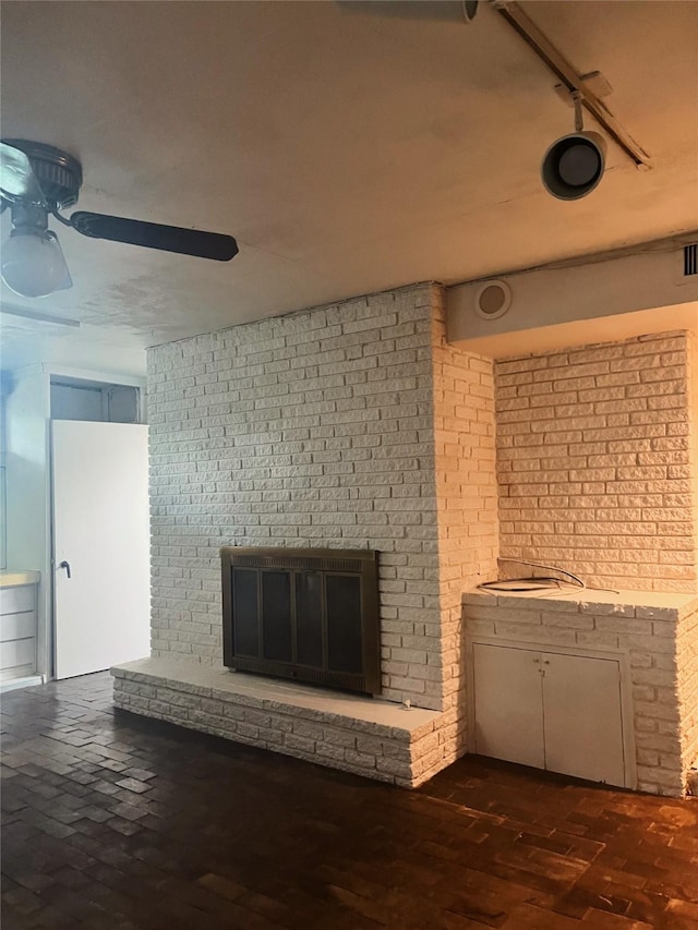1934 Kessler Pkwy, Dallas, TX 75208 - unfurnished living room featuring a brick fireplace, a ceiling fan, and rail lighting