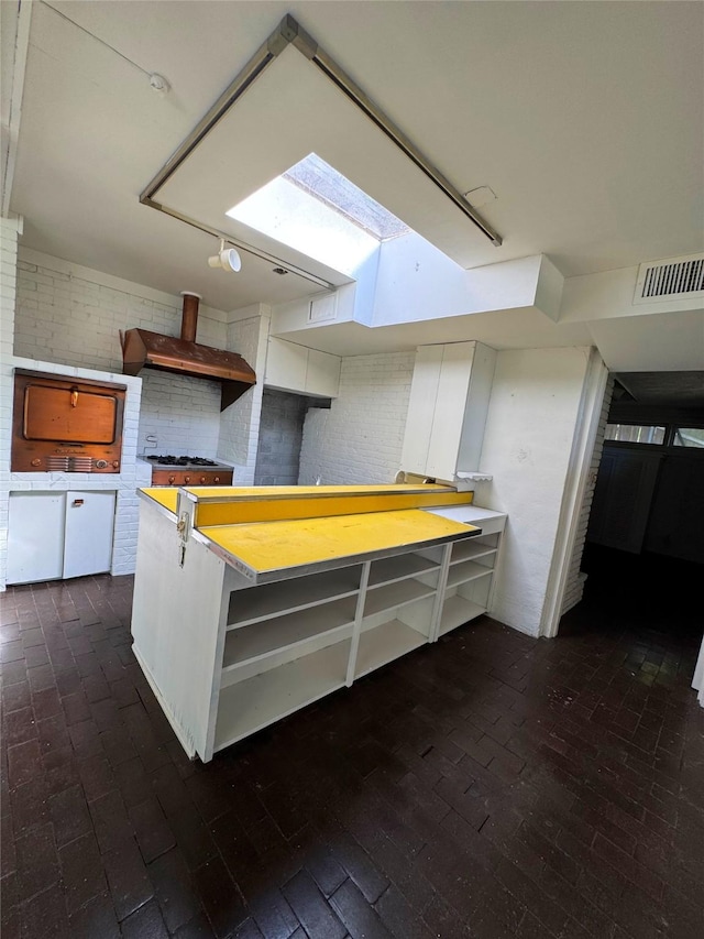 1934 Kessler Pkwy, Dallas, TX 75208 - kitchen featuring brick floors, a skylight, custom exhaust hood, and open shelves