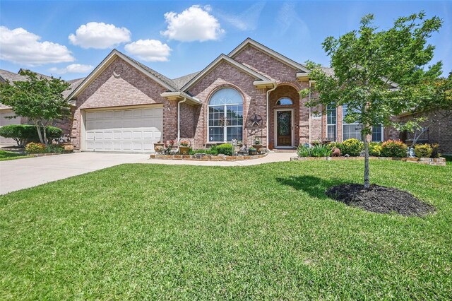 2813 Calico Rock Dr, Fort Worth, TX 76131 - view of front of house featuring concrete driveway, brick siding, an attached garage, and a front lawn