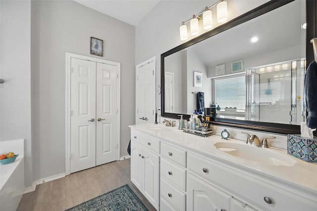 2813 Calico Rock Dr, Fort Worth, TX 76131 - full bathroom with a shower stall, double vanity, wood finished floors, and baseboards