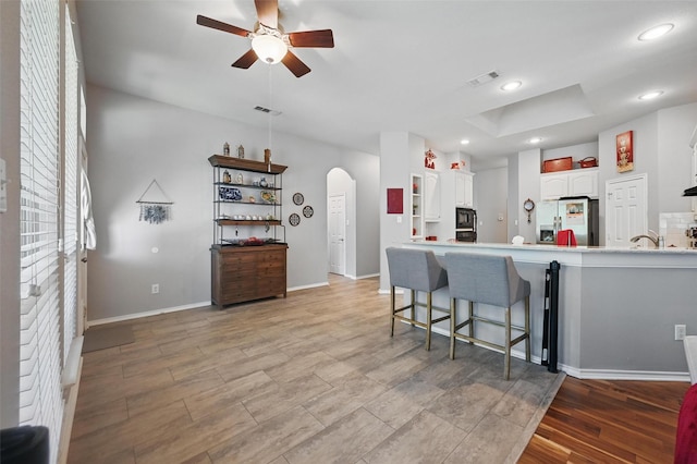 2813 Calico Rock Dr, Fort Worth, TX 76131 - kitchen featuring black microwave, open shelves, arched walkways, a ceiling fan, and stainless steel refrigerator with ice dispenser
