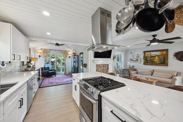 8538 Grenadier Dr, Dallas, TX 75238 - kitchen with open floor plan, appliances with stainless steel finishes, ceiling fan, island exhaust hood, and light stone countertops