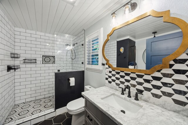 8538 Grenadier Dr, Dallas, TX 75238 - bathroom featuring a walk in shower, toilet, vanity, tasteful backsplash, and tile patterned flooring