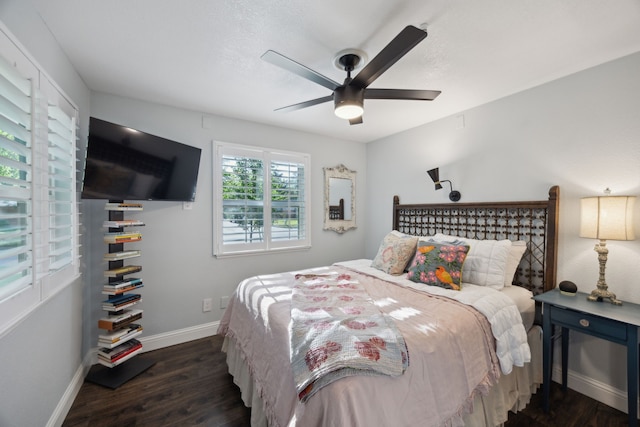8538 Grenadier Dr, Dallas, TX 75238 - bedroom with dark wood finished floors, baseboards, and a ceiling fan