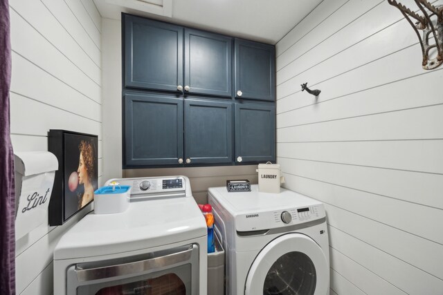 8538 Grenadier Dr, Dallas, TX 75238 - laundry room with cabinet space, independent washer and dryer, and wood walls
