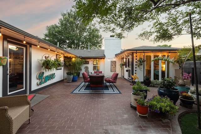 8538 Grenadier Dr, Dallas, TX 75238 - patio terrace at dusk featuring outdoor dining space