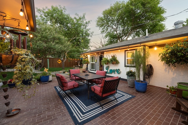 8538 Grenadier Dr, Dallas, TX 75238 - patio terrace at dusk featuring outdoor dining area and fence