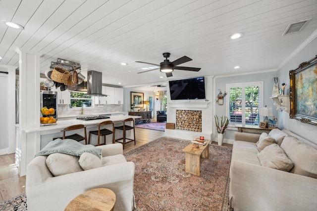 8538 Grenadier Dr, Dallas, TX 75238 - living room with light wood-type flooring, crown molding, recessed lighting, ceiling fan, and baseboards