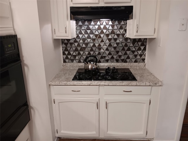 12249 High Pointe Cir, Dallas, TX 75243 - kitchen featuring under cabinet range hood, black appliances, a warming drawer, tasteful backsplash, and white cabinets