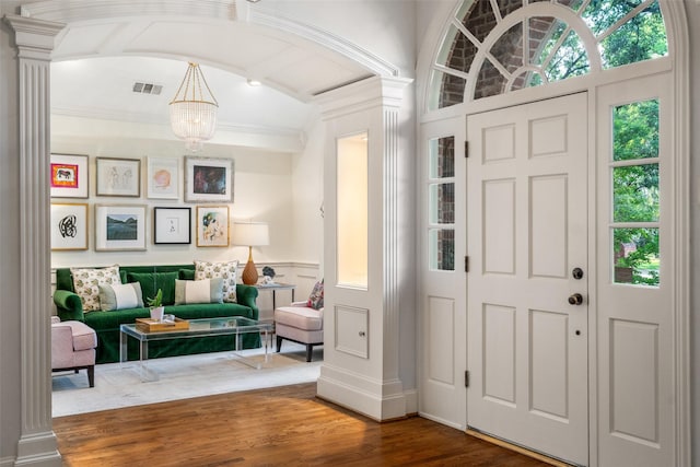 4710 Bobbitt Dr, Dallas, TX 75229 - entrance foyer with a chandelier, wood finished floors, ornate columns, and ornamental molding