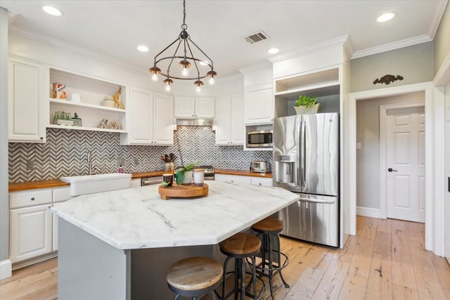 1345 Stillwater Rd, Waco, TX 76708 - kitchen featuring open shelves, stainless steel appliances, white cabinets, under cabinet range hood, and hanging light fixtures