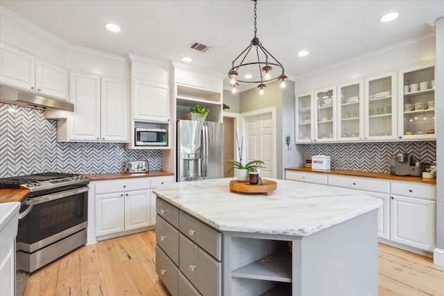 1345 Stillwater Rd, Waco, TX 76708 - kitchen with open shelves, stainless steel appliances, under cabinet range hood, white cabinetry, and ornamental molding